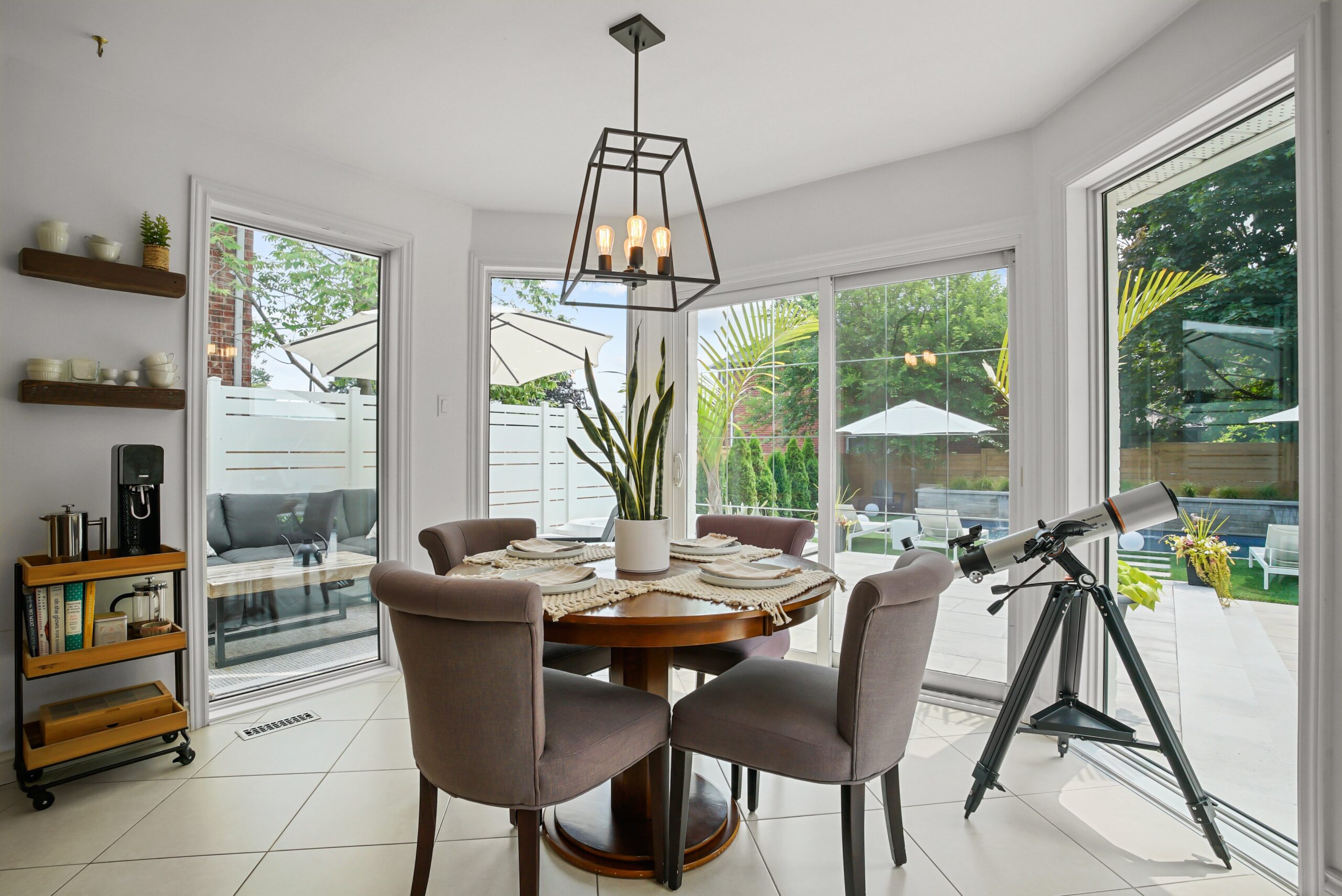 Breakfast nook with bay window and view to backyard pool patio in Cambridge home