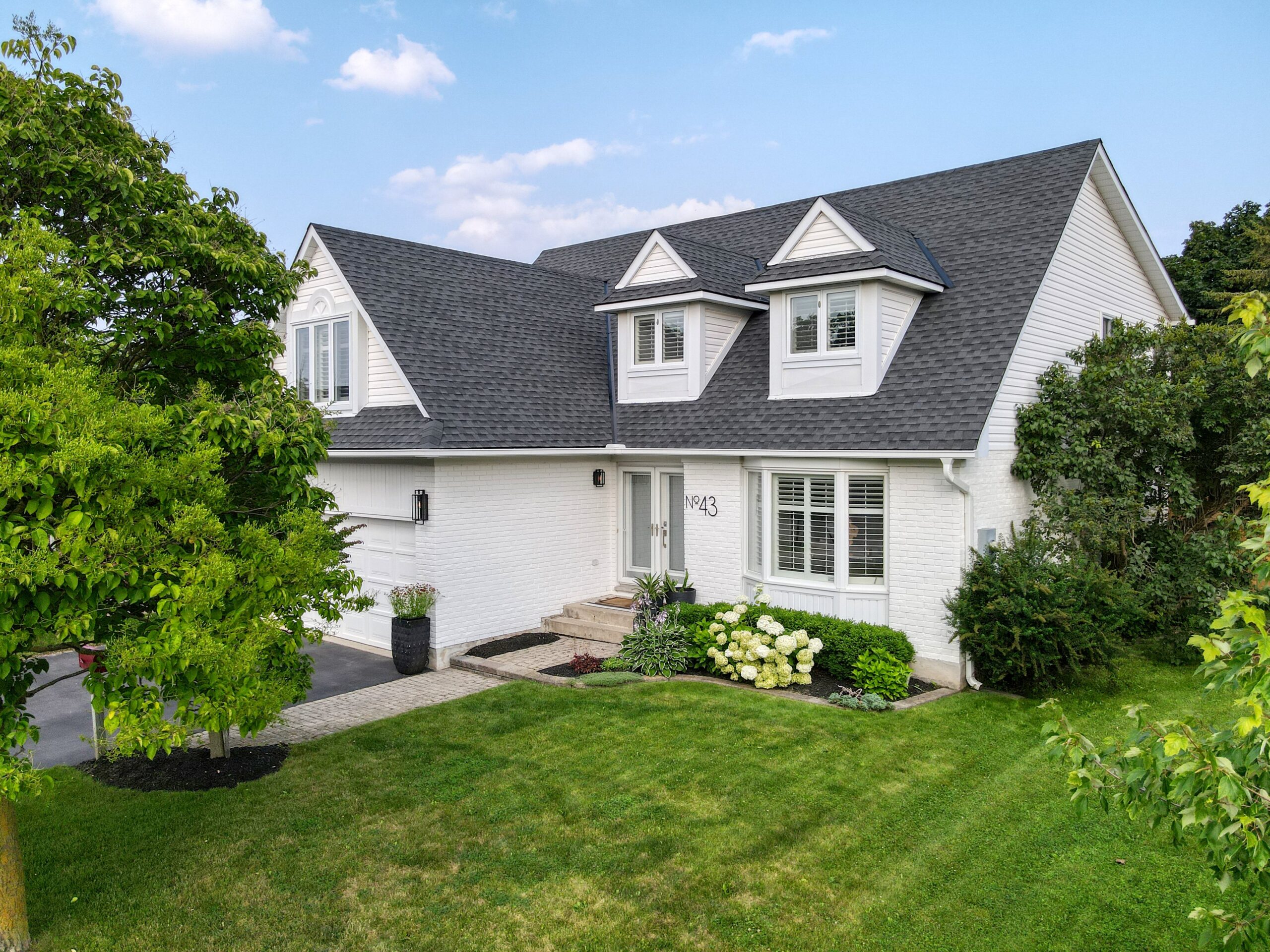 Front exterior of white-painted family home in Cambridge