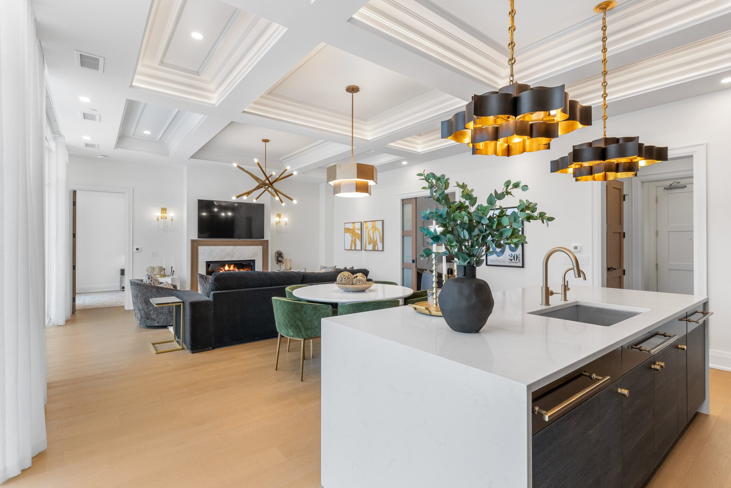 Dining area with treetop view and white kitchen at Elora Mill Residences