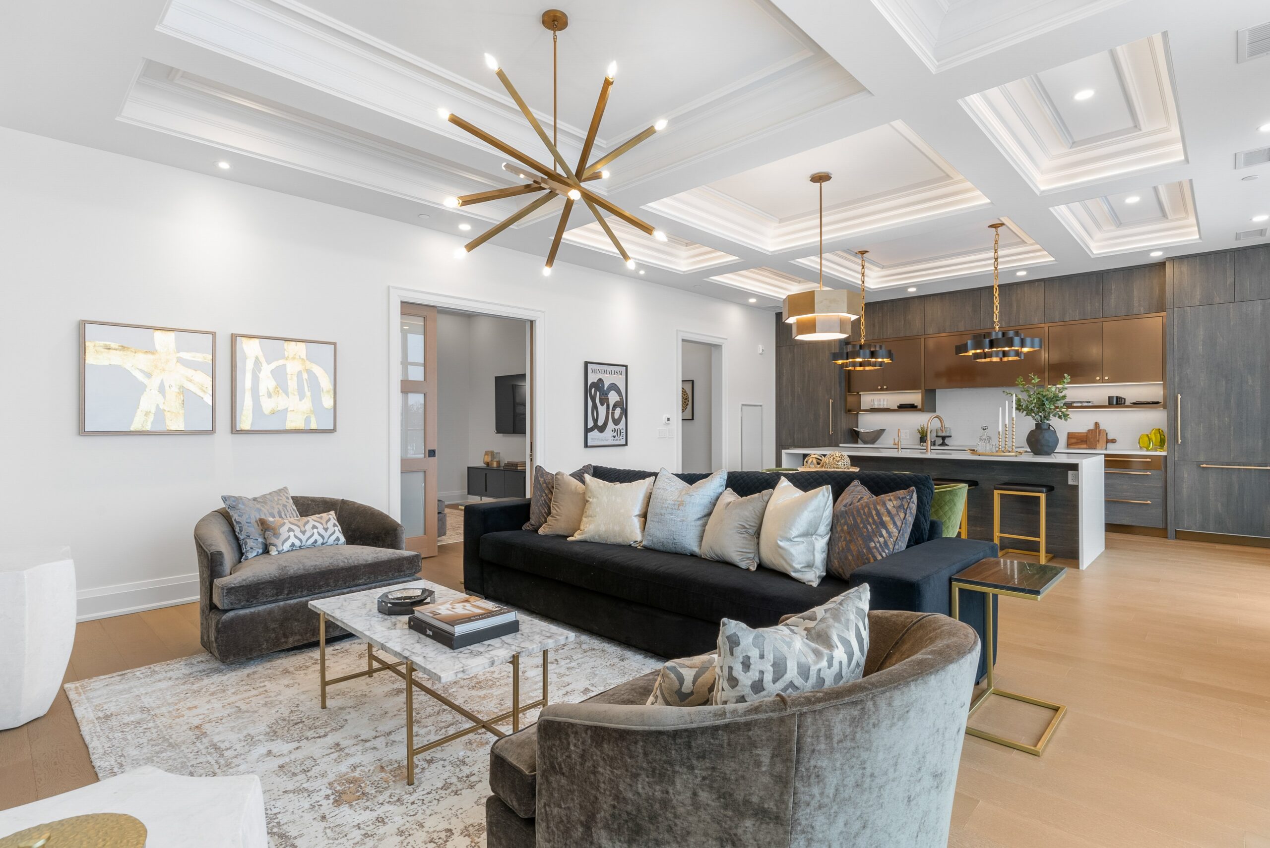 Living room with sputnik chandelier and coffered ceiling at Elora Mill