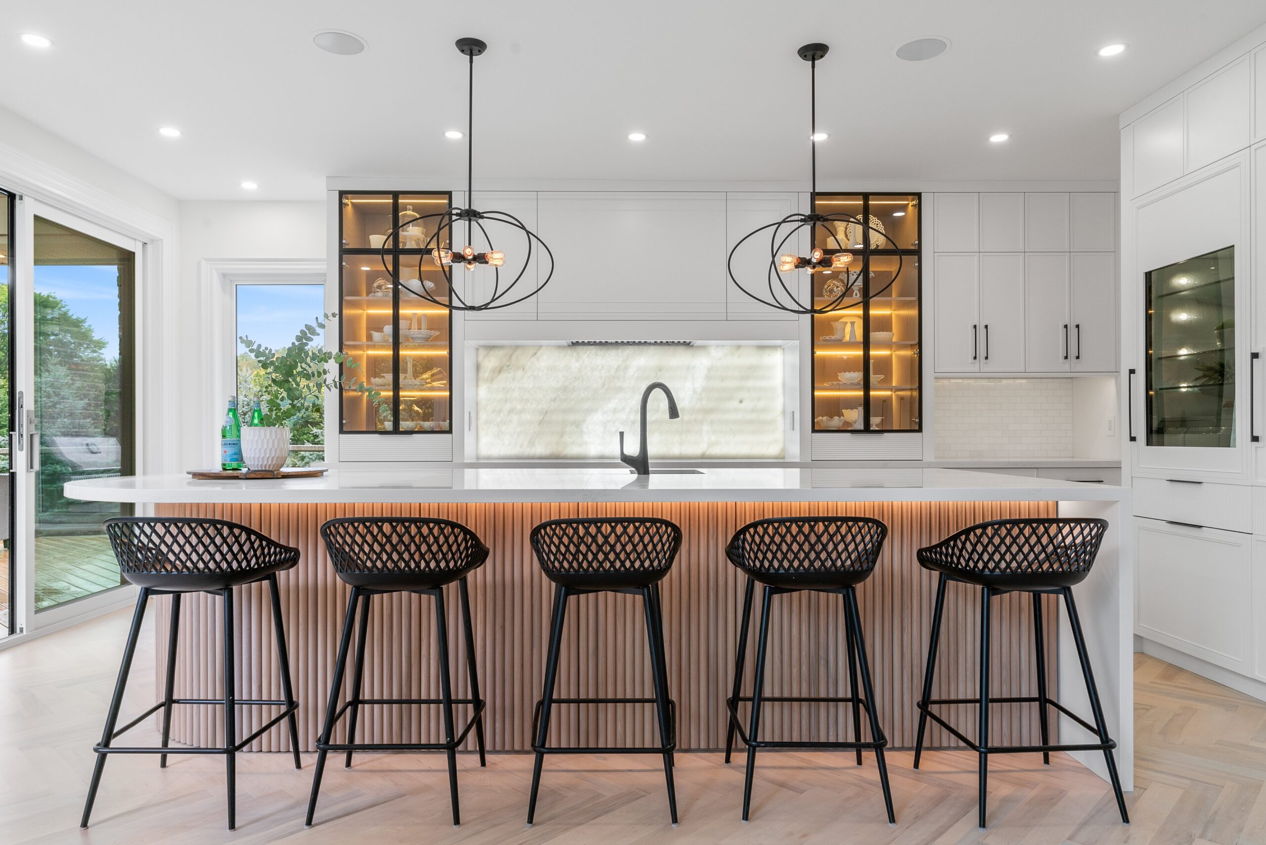 Modern luxury kitchen with marble backsplash and ribbed wood island in Heidelberg custom home