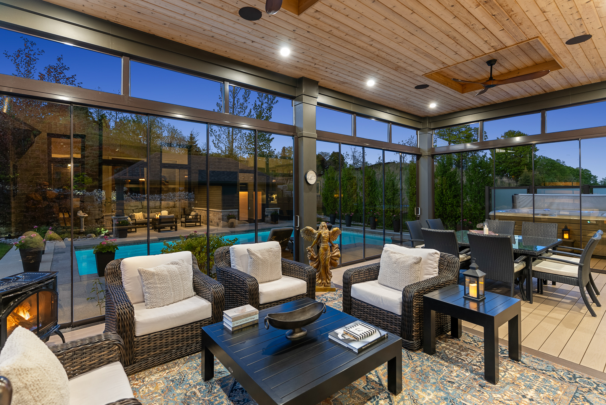 Twilight photo of covered outdoor lounge with pool view at Hidden Valley estate