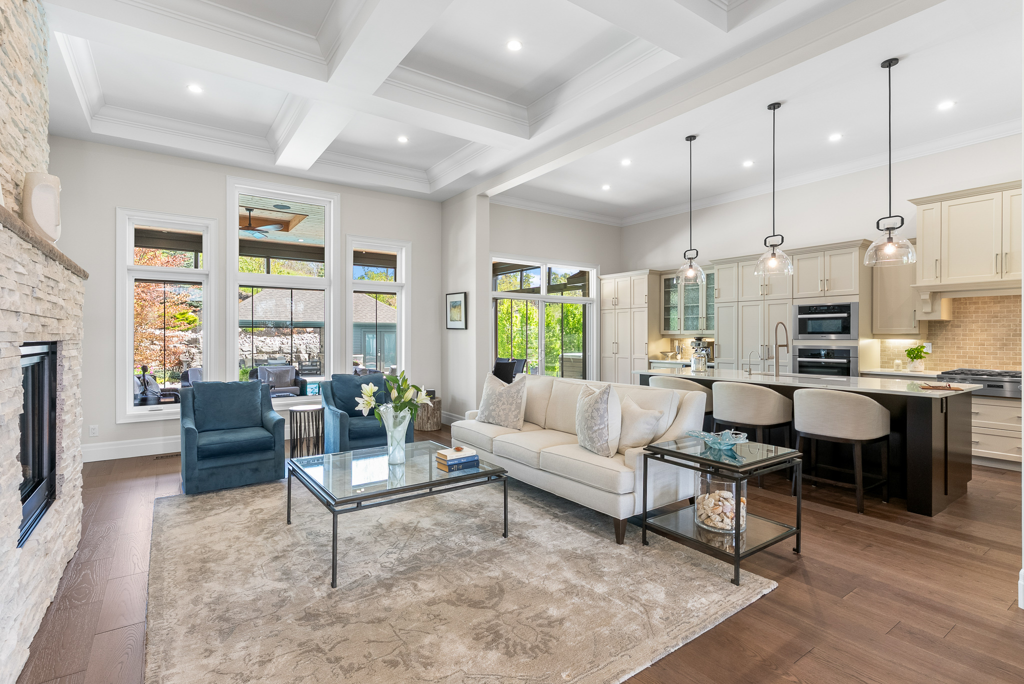 Open concept living and kitchen with coffered ceiling at Hidden Valley estate