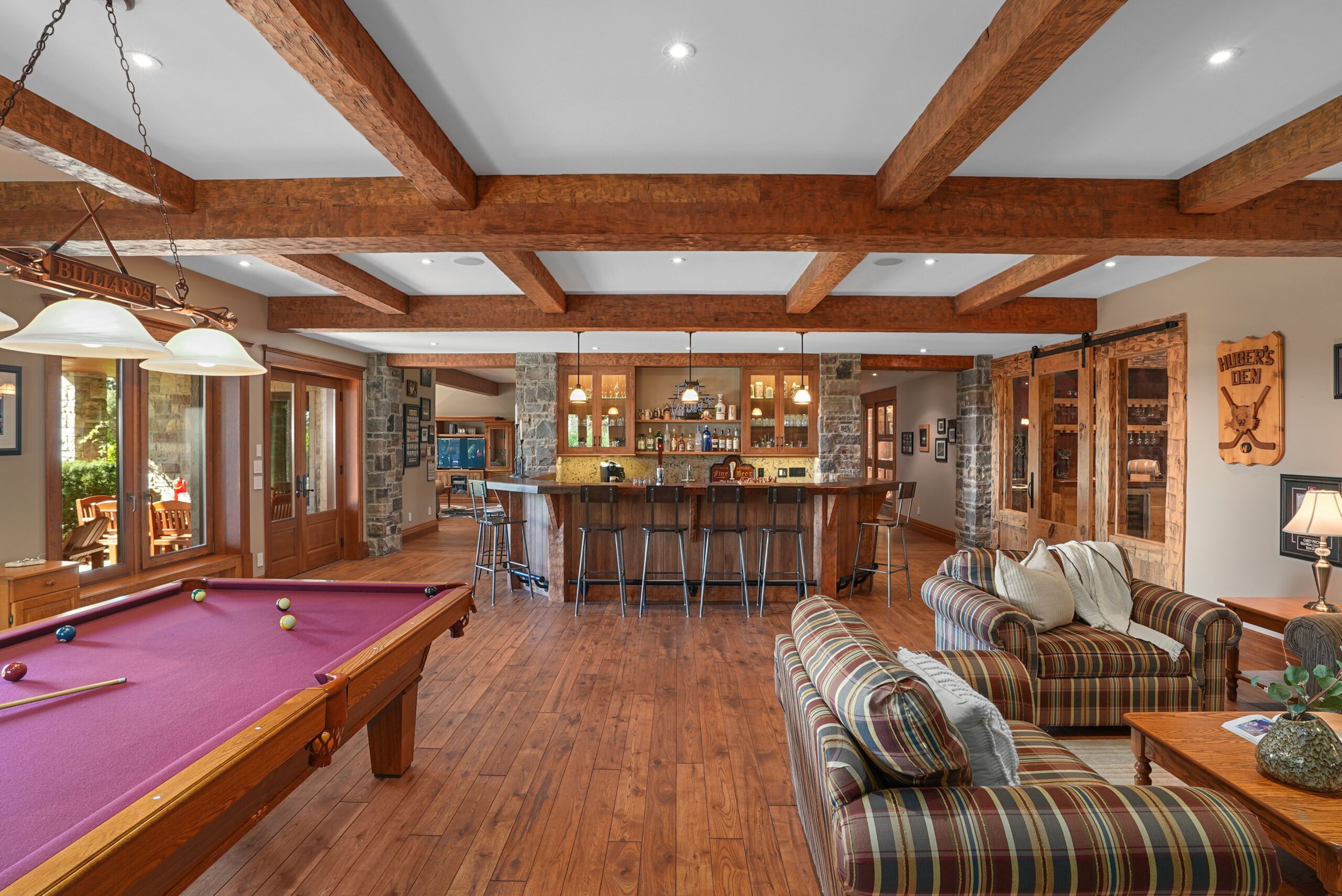 Rustic kitchen with wood beams and long dining table for twelve at Waterloo estate