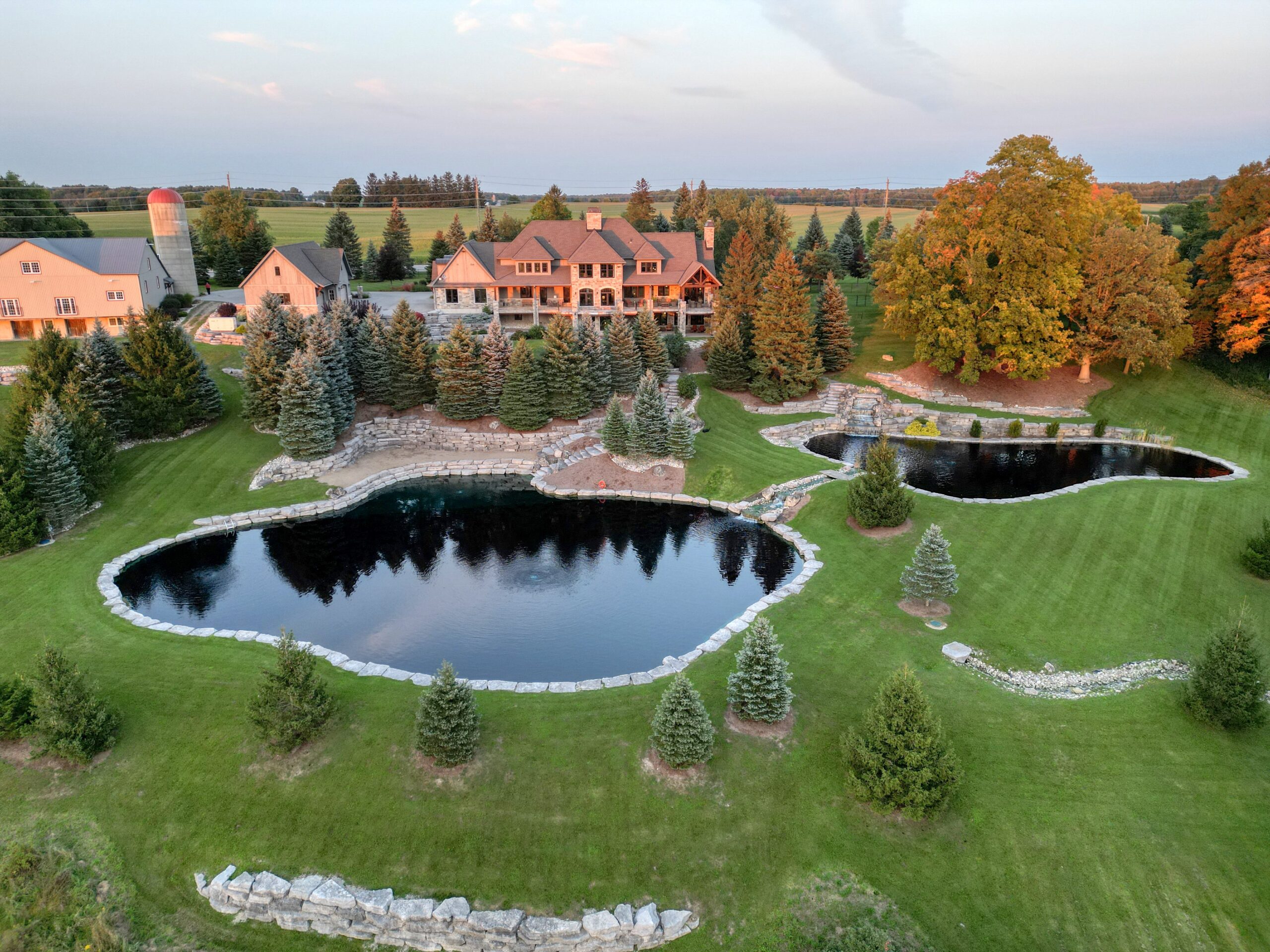 Landscaped ponds with stone walls and waterfall at Waterloo country estate